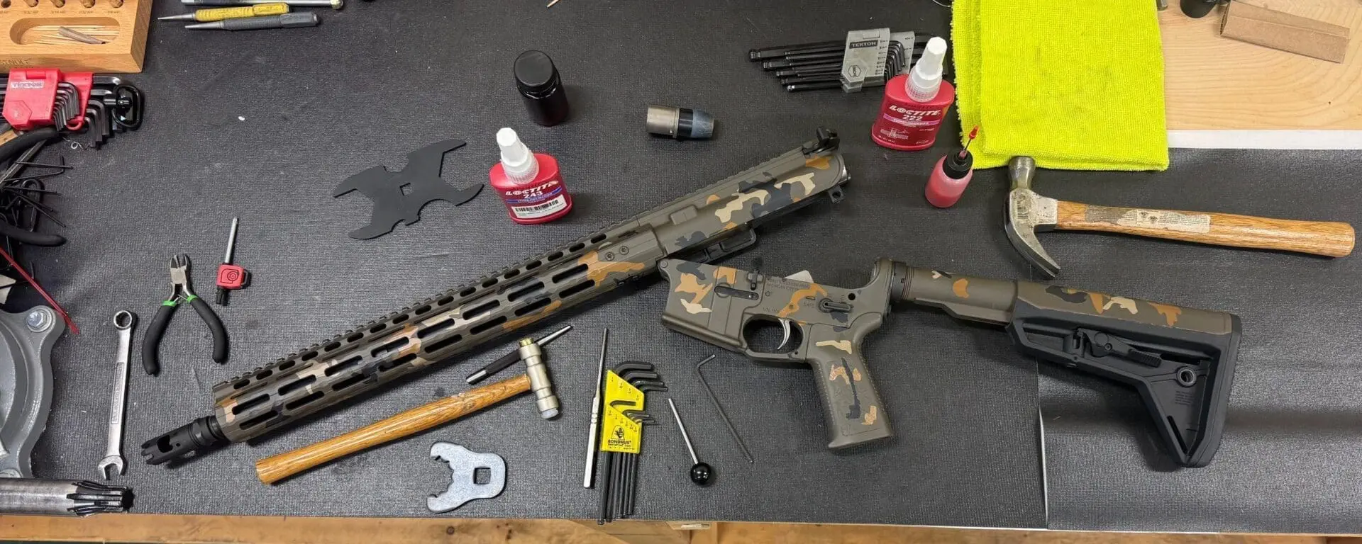AR rifle parts and tools on workbench
