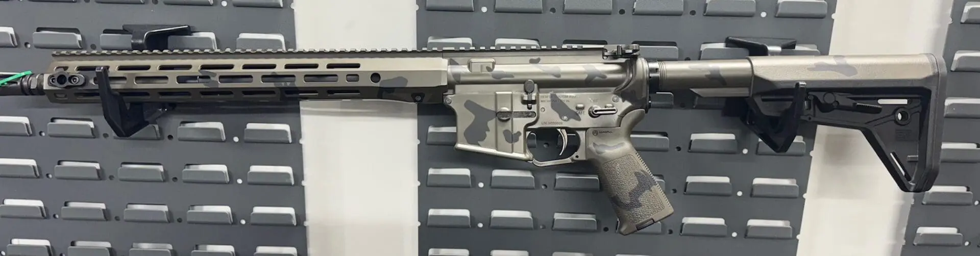 Close-up of a disassembled firearm component on a textured surface.